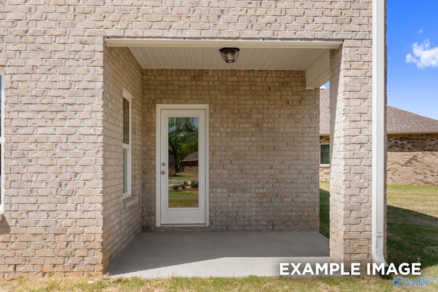 property entrance with brick siding