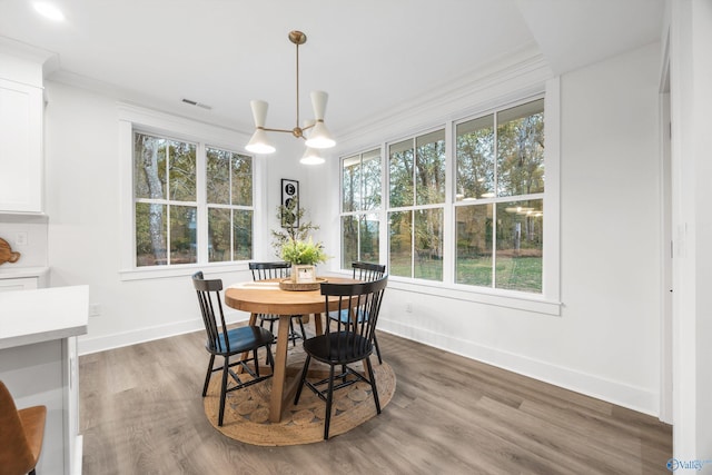 dining room featuring visible vents, a notable chandelier, wood finished floors, and a wealth of natural light