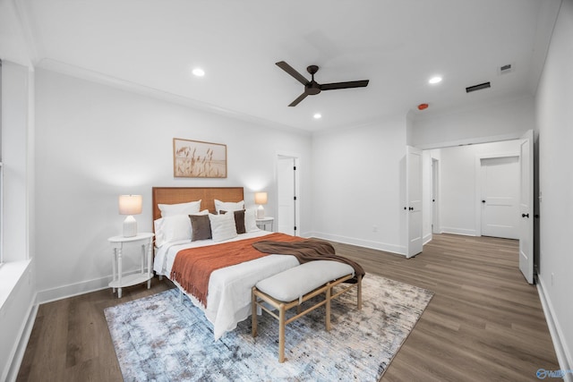 bedroom with baseboards, recessed lighting, wood finished floors, and visible vents
