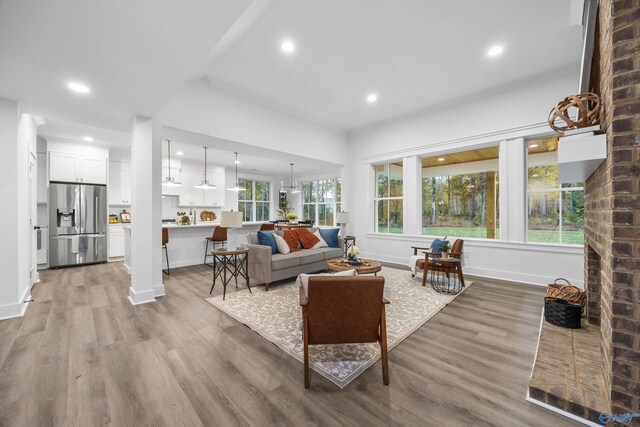 living room featuring recessed lighting, baseboards, and wood finished floors