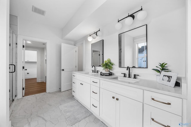 bathroom featuring vanity, hardwood / wood-style flooring, and a shower with shower door