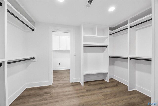 walk in closet featuring visible vents and wood finished floors