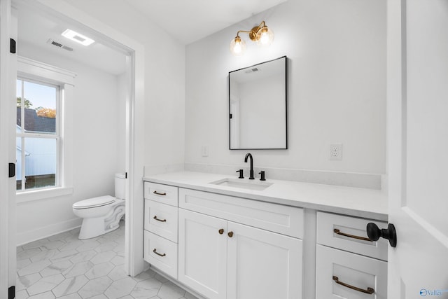 bathroom featuring vanity and toilet