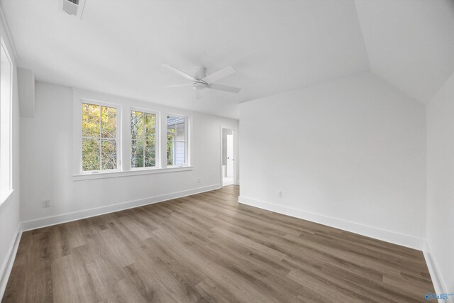 empty room with baseboards, a ceiling fan, and wood finished floors
