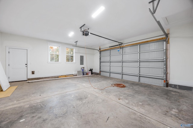 garage with a garage door opener and electric panel