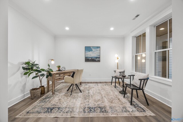 office space with baseboards, wood finished floors, and visible vents