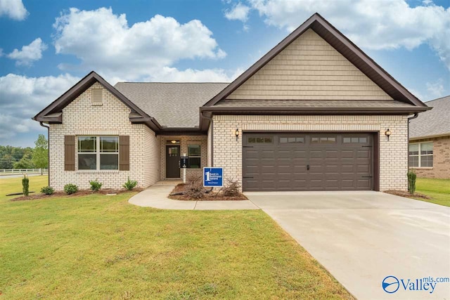 craftsman-style home featuring a front yard, concrete driveway, brick siding, and an attached garage