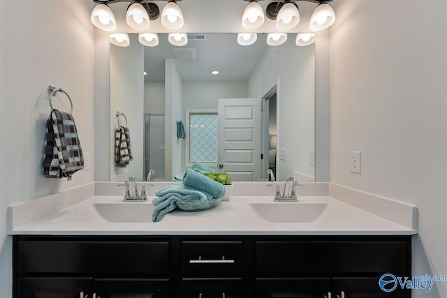 bathroom featuring vanity and a shower with shower door