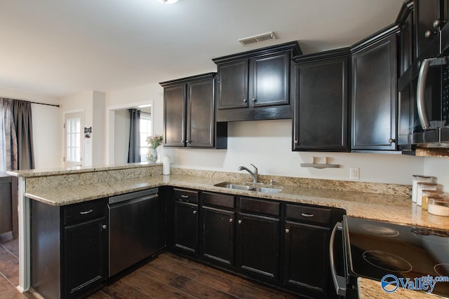 kitchen featuring sink, light stone counters, electric range, stainless steel dishwasher, and dark hardwood / wood-style floors