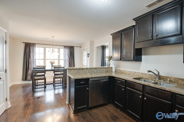 kitchen featuring dark hardwood / wood-style floors, decorative light fixtures, sink, stainless steel dishwasher, and kitchen peninsula