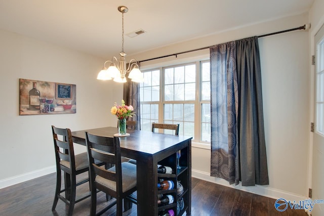 dining room featuring plenty of natural light, dark hardwood / wood-style flooring, and a notable chandelier