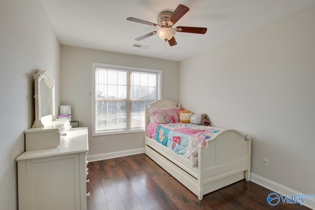 bedroom with ceiling fan and dark hardwood / wood-style flooring