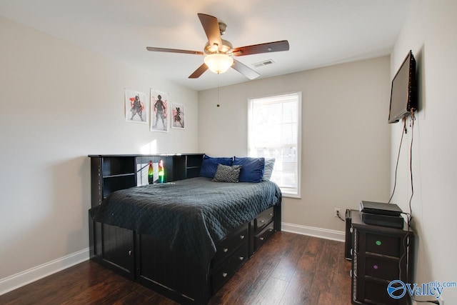 bedroom featuring multiple windows, dark hardwood / wood-style floors, and ceiling fan