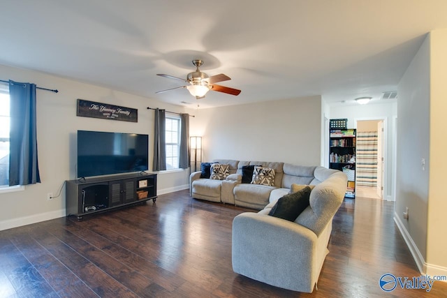 living room with dark wood-type flooring and ceiling fan