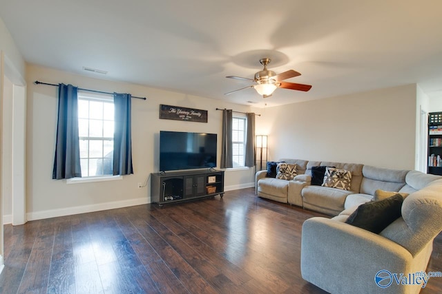 living room with dark wood-type flooring and ceiling fan