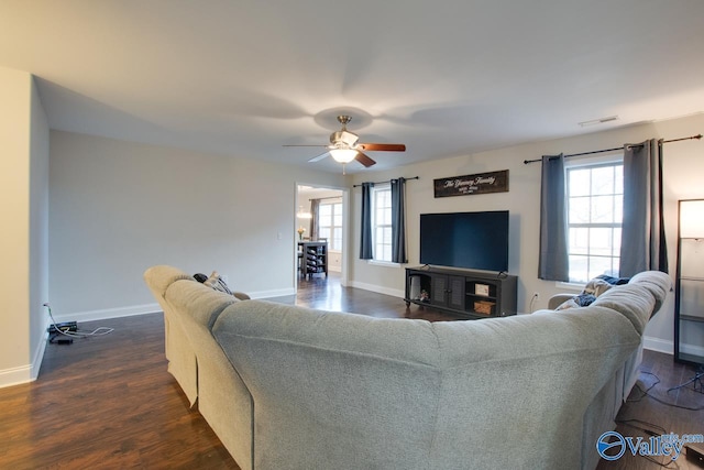 living room with dark wood-type flooring and ceiling fan