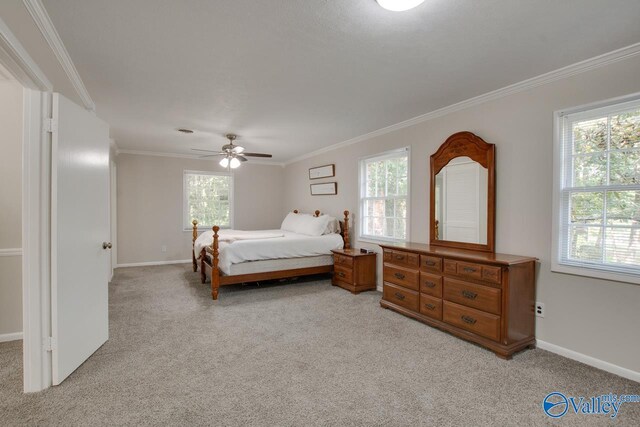 bedroom with crown molding, light colored carpet, and ceiling fan