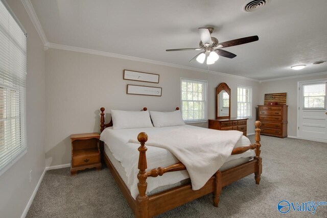 bedroom with light carpet, multiple windows, and ceiling fan