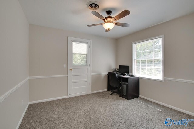 office space featuring light colored carpet, plenty of natural light, and ceiling fan