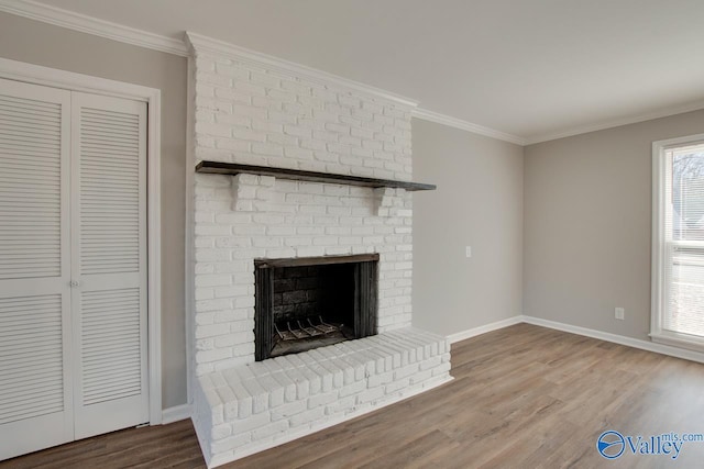 unfurnished living room featuring crown molding, a fireplace, and wood-type flooring