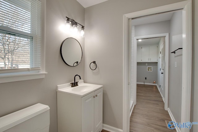 bathroom featuring hardwood / wood-style flooring, vanity, and toilet