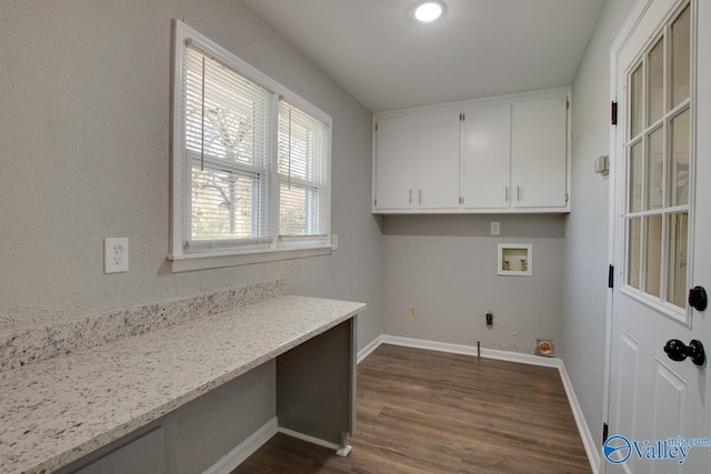 laundry area featuring washer hookup, dark hardwood / wood-style floors, and cabinets