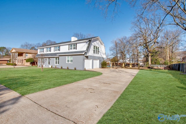 view of front of property with a garage and a front lawn