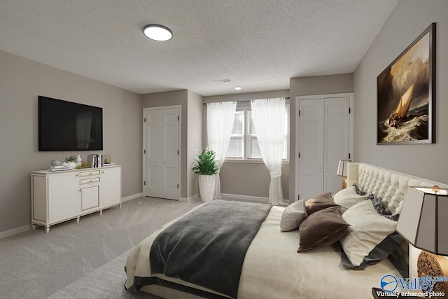 carpeted bedroom with a textured ceiling