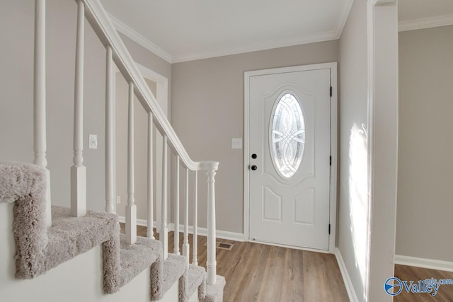 entryway featuring crown molding and light hardwood / wood-style floors