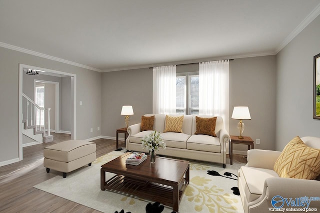 living room featuring crown molding and light hardwood / wood-style flooring