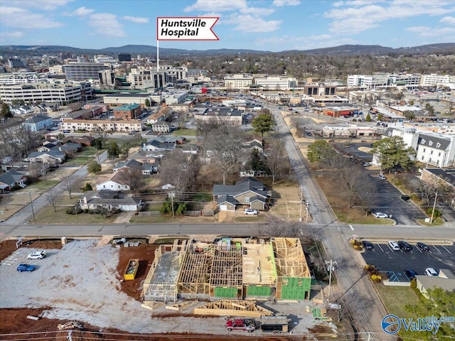 birds eye view of property featuring a city view and a mountain view