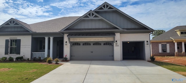 craftsman house with a porch, a garage, and a front lawn