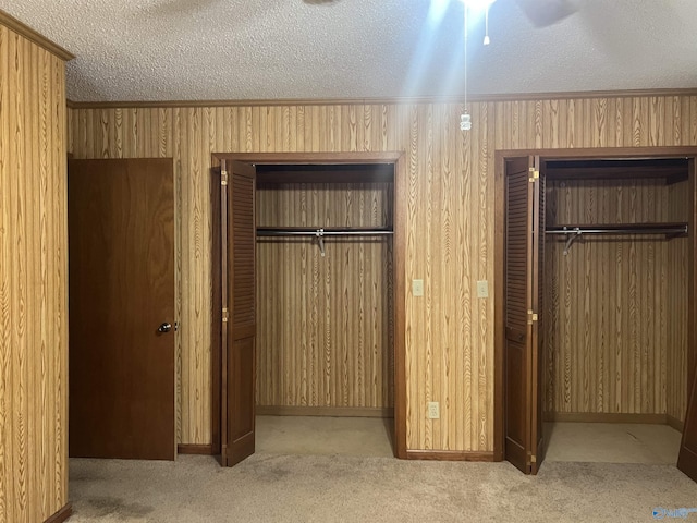 unfurnished bedroom featuring a closet, a textured ceiling, and carpet