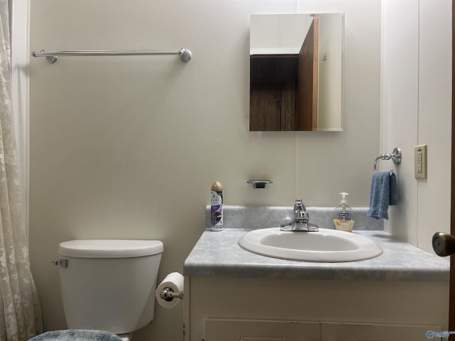 bathroom featuring toilet and vanity