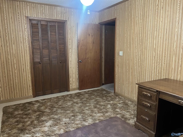 interior space featuring carpet flooring and wooden walls
