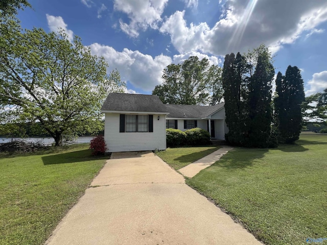 view of front of home featuring concrete driveway and a front yard