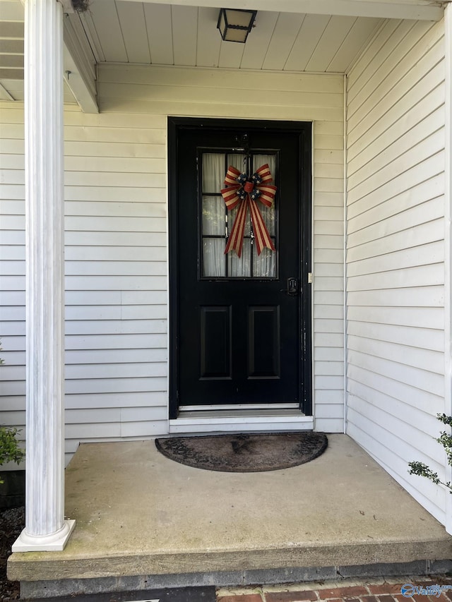 view of exterior entry featuring a porch