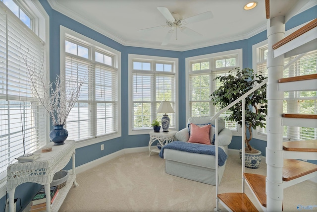 sunroom featuring ceiling fan