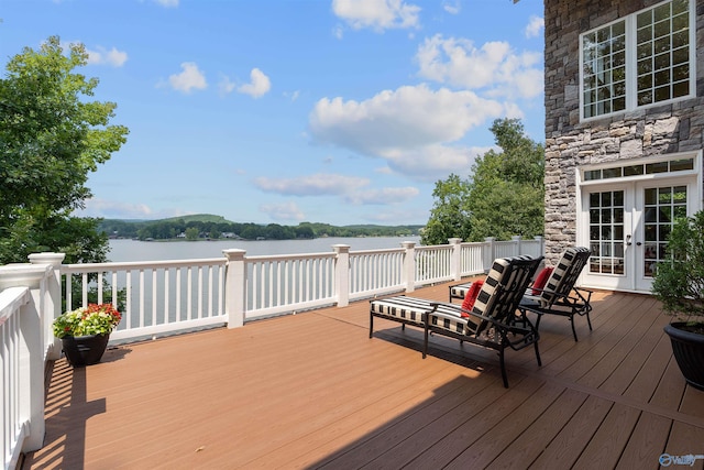 deck with a water view and french doors