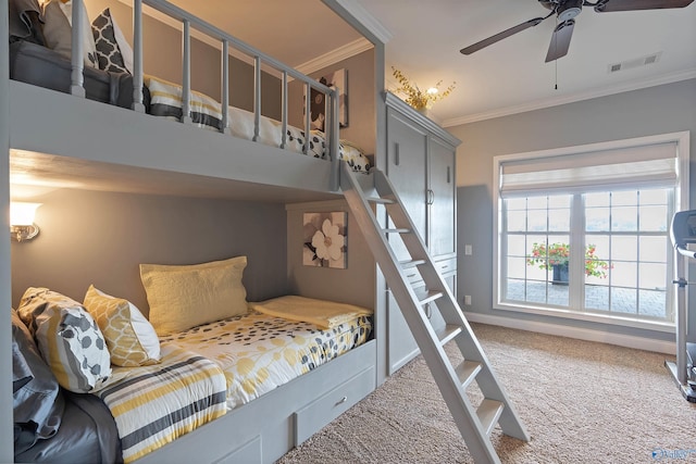 bedroom with carpet floors, crown molding, and ceiling fan