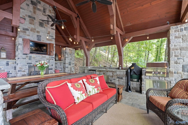 view of patio with ceiling fan, an outdoor living space with a fireplace, a gazebo, and area for grilling