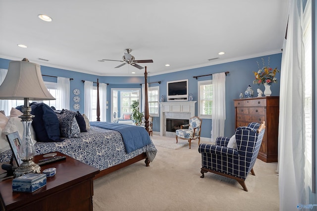 carpeted bedroom with ceiling fan and ornamental molding