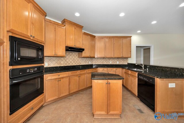 118 Conservancy Dr, Madison, AL 35758 - kitchen with black appliances, under cabinet range hood, a peninsula, light tile patterned floors, and dark stone counters