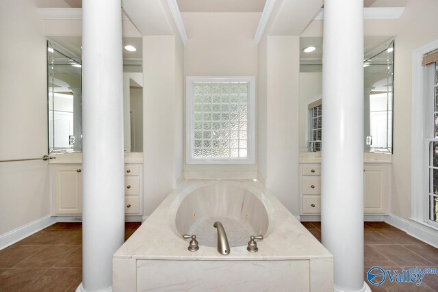 118 Conservancy Dr, Madison, AL 35758 - bathroom with a jetted tub, decorative columns, and tile patterned flooring