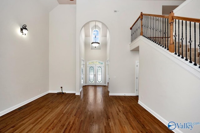 118 Conservancy Dr, Madison, AL 35758 - foyer entrance featuring wood finished floors, a high ceiling, arched walkways, and french doors