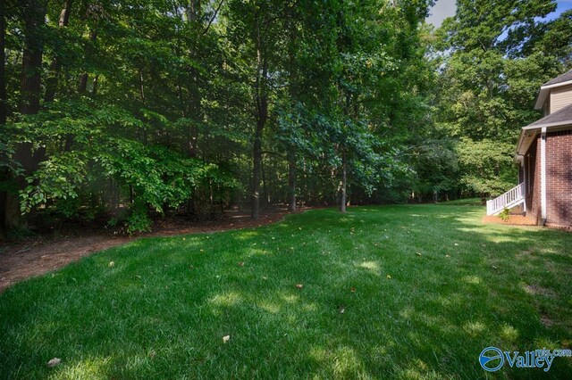 118 Conservancy Dr, Madison, AL 35758 - view of grassy yard featuring a wooded view