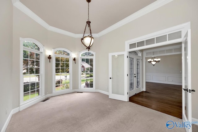 118 Conservancy Dr, Madison, AL 35758 - unfurnished dining area with a chandelier, crown molding, plenty of natural light, and carpet flooring