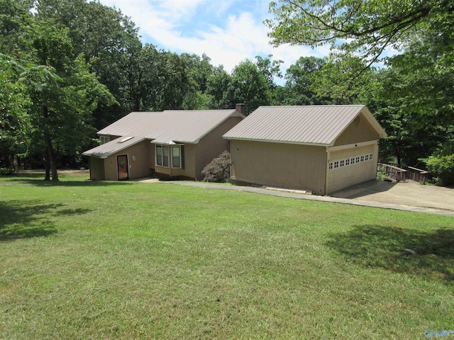 109 Colonial Dr, Scottsboro, AL 35768 - view of front facade featuring metal roof, a front lawn, and an attached garage