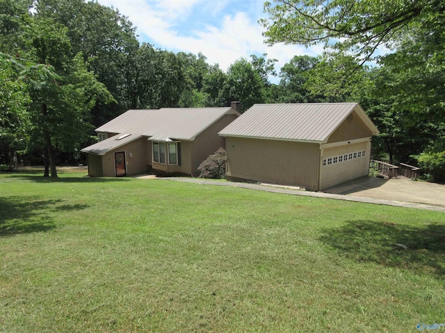 view of front facade featuring metal roof, a front lawn, and an attached garage