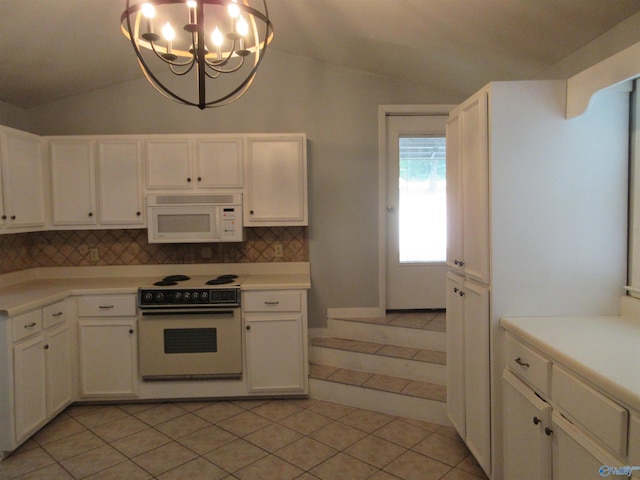 109 Colonial Dr, Scottsboro, AL 35768 - kitchen featuring lofted ceiling, white appliances, and light countertops